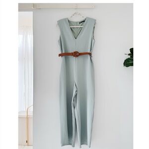 Light blue/light teal sleeveless jumpsuit with belt and shoulder-pads(!!!)